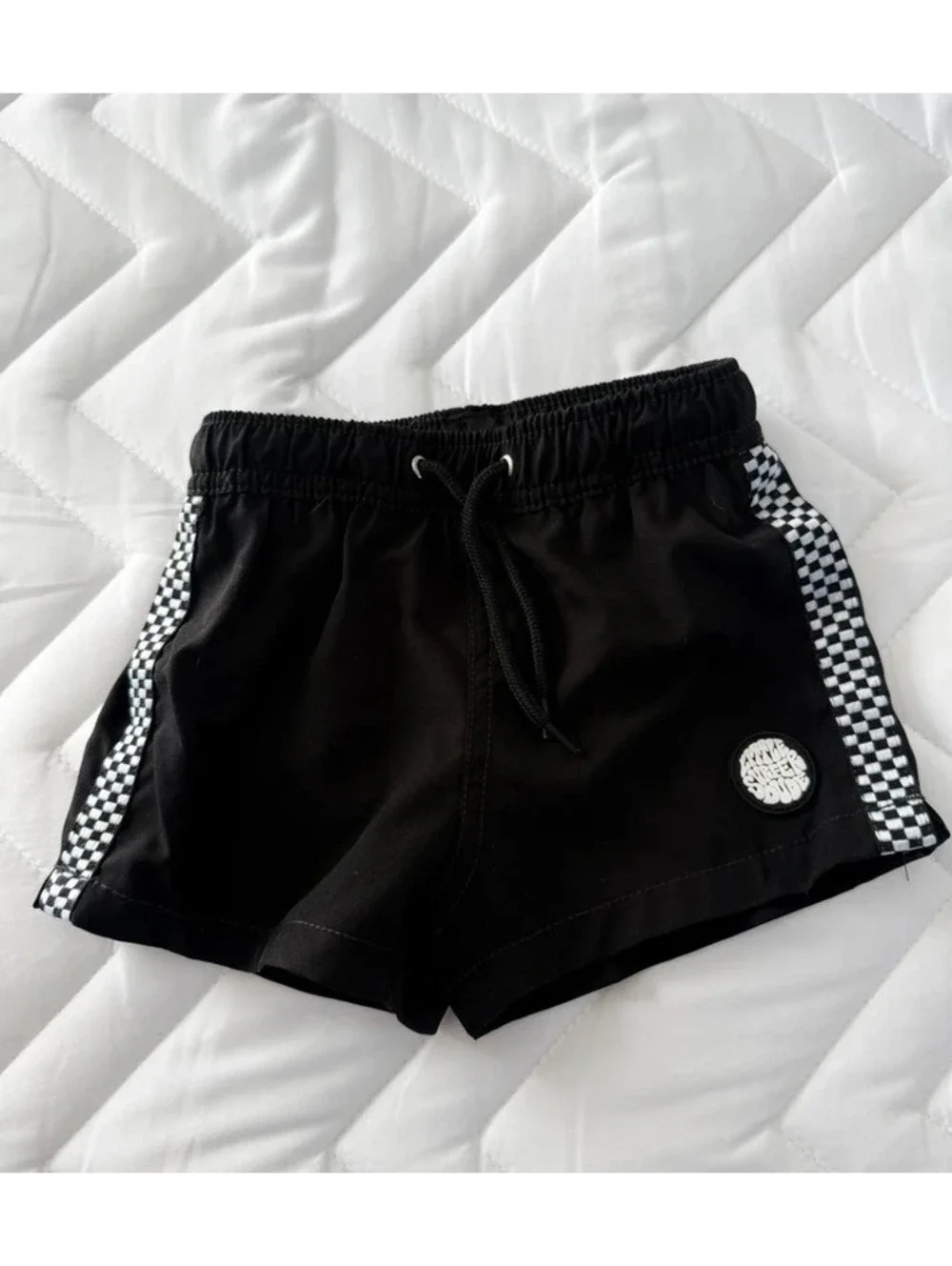 Little surfer dude black checkered swim shorts